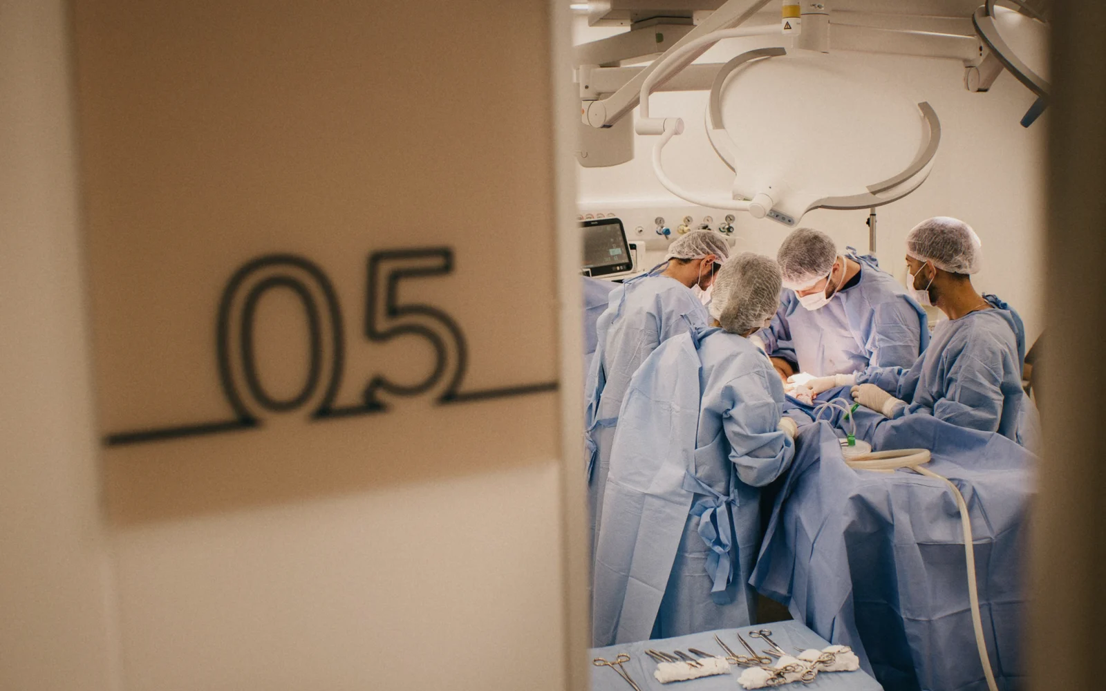 A surgical team at work, seen through the door of operating room 05